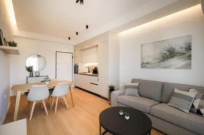 a living room with a couch and a table at Piraeus Riviera Residence in Piraeus