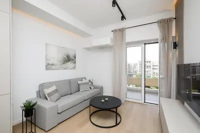 a living room with a couch and a table at Piraeus Riviera Residence in Piraeus