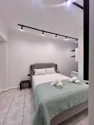 a bedroom with a bed with two towels on it at Family Luxury Suite by Zeus Suites in Athens