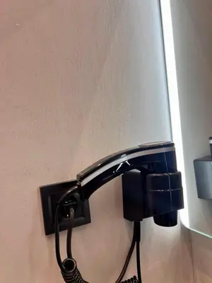 a black lamp is attached to a wall at Family Luxury Suite by Zeus Suites in Athens