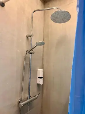 a shower with a shower head in a bathroom at Family Luxury Suite by Zeus Suites in Athens