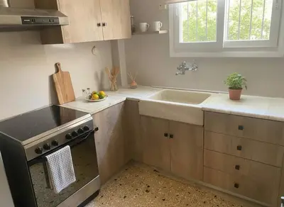 a kitchen with a sink and a stove at Bright 2-Bedroom Apt in Ampelokipoi Near Hospital in Athens