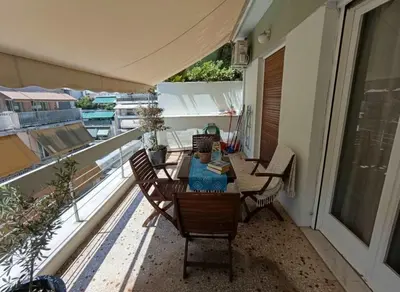 a balcony with a table and chairs on a balcony at Bright 2-Bedroom Apt in Ampelokipoi Near Hospital in Athens