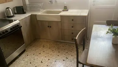 a kitchen with a sink and a table and a table and a tableablish at Bright 2-Bedroom Apt in Ampelokipoi Near Hospital in Athens