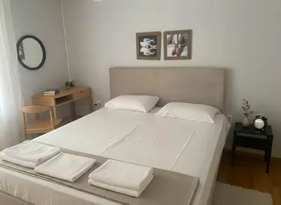 a bedroom with a large white bed with a mirror at Bright 2-Bedroom Apt in Ampelokipoi Near Hospital in Athens