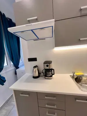a kitchen with a counter top with a coffeemaker at Zeus Luxury Suite by Zeus Suites in Athens