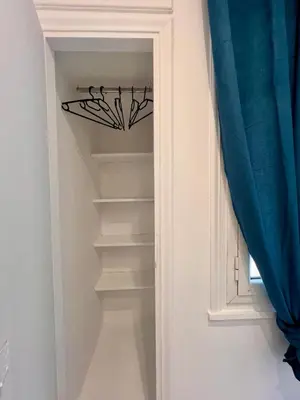 a stairway with a blue curtain next to a door at Zeus Luxury Suite by Zeus Suites in Athens
