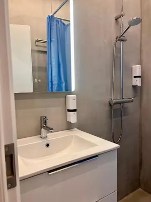 a bathroom with a white sink and a mirror at Zeus Luxury Suite by Zeus Suites in Athens