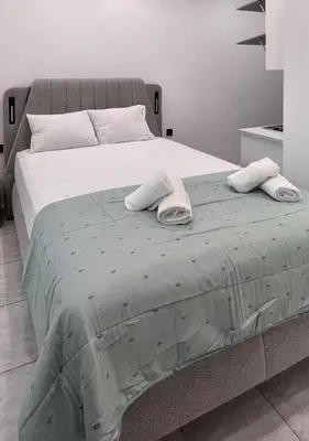 a large bed with two towels on top of it at Hera Luxury Suite by Zeus Suites in Athens