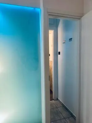 a hallway with a door to a room with blue lights at Hera Luxury Suite by Zeus Suites in Athens