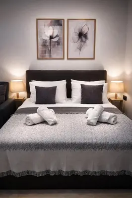 a bedroom with a bed with two towels on it at JASMIN Luxury Apartment in Athens