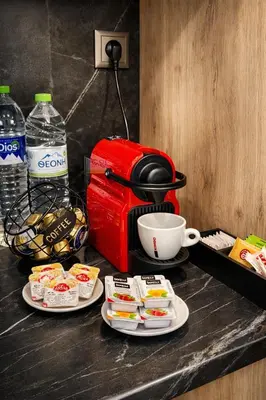 a table with two plates of food and a coffee maker at JASMIN Luxury Apartment in Athens