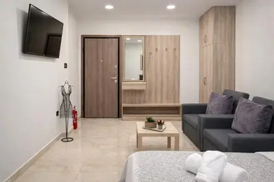 a living room with a couch and a tv in it at JASMIN Luxury Apartment in Athens