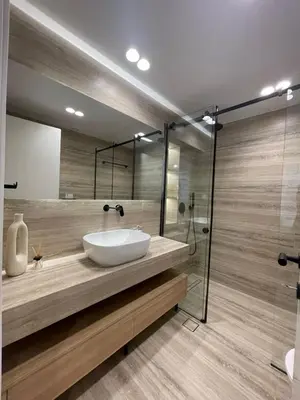 a bathroom with a sink and a glass shower at Voula Lemon Garden by Taurus in Athens