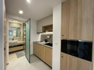 a small kitchen with a sink and a bathroom at Voula Olive Garden by Taurus in Athens