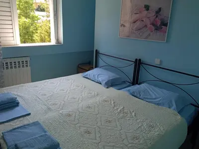 a bedroom with a bed with blue walls at Comfortable apartment by the Metro in Athens