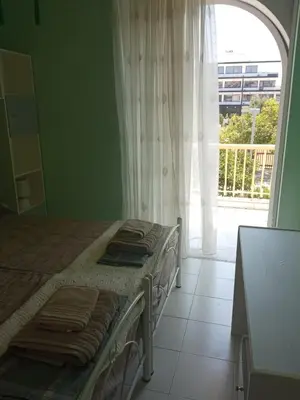 a bedroom with a bed and a large window at Comfortable apartment by the Metro in Athens