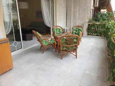 a patio with a table and chairs on a porch at Comfortable apartment by the Metro in Athens