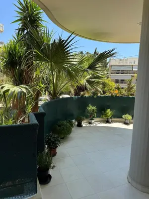 a courtyard with potted plants in a building at Oasis 3 minutes from the beach in Vari