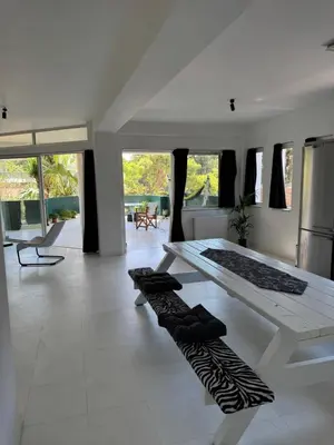 a white room with a table and some towels on the floor at Oasis 3 minutes from the beach in Vari