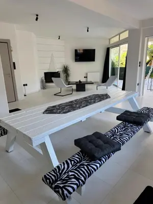 a white table with pillows on the floor in a living room at Oasis 3 minutes from the beach in Vari