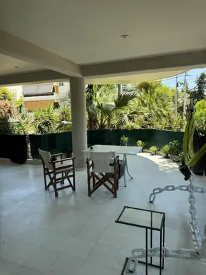 a patio with a table and chairs and trees at Oasis 3 minutes from the beach in Vari