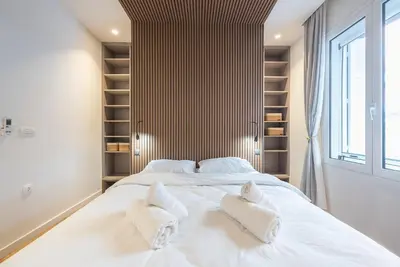 a bedroom with a large white bed with white pillows at Modern 1BR in Exarchia l Green-View Balcony in Athens