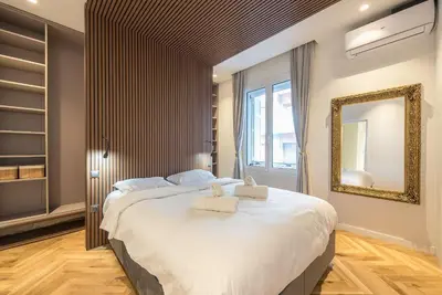 a bedroom with a large bed with towels on it at Modern 1BR in Exarchia l Green-View Balcony in Athens