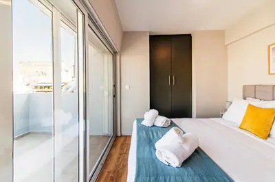 a bedroom with a bed with towels on it at Kali 56 in Athens