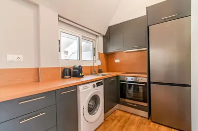 a kitchen with a washing machine and a washer at Kali 56 in Athens