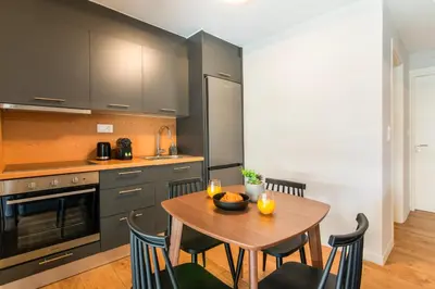 a kitchen with a wooden table and chairs in a kitchen at Kali 56 in Athens