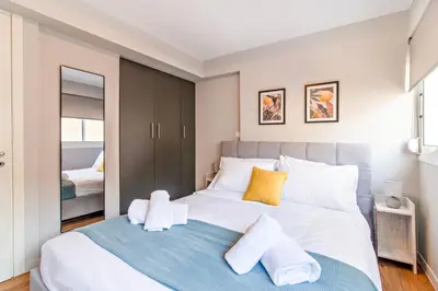 a bedroom with a large bed with towels on it at Kali 56 in Athens