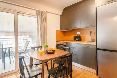 a kitchen and dining room with a table and chairs at Kali 56 in Athens