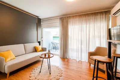 a living room with a couch and a table at Kali 56 in Athens