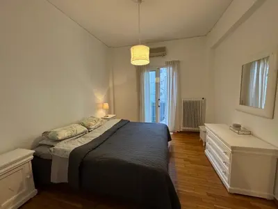 a bedroom with a large bed and a window at Arisa Apartment in Athens next to Metro Station in Athens