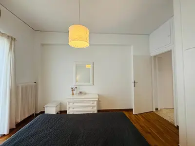 a bedroom with a bed and a white dresser at Arisa Apartment in Athens next to Metro Station in Athens