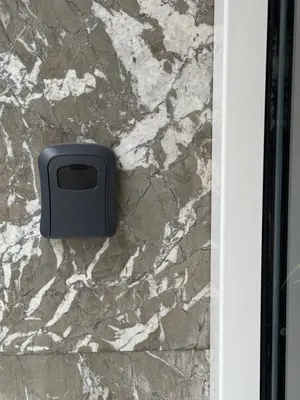 a soap dispenser on the side of a marble wall at Arisa Apartment in Athens next to Metro Station in Athens