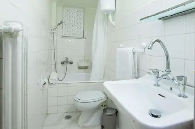 a white bathroom with a toilet and a sink at Cozy Minimal Studio by Ampelokipoi Metro in Athens