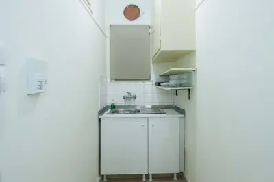 a small kitchen with a sink in a room at Cozy Minimal Studio by Ampelokipoi Metro in Athens