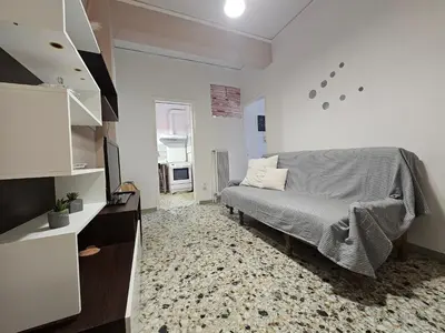 a bedroom with a bed and a tv in it at Come & Stay Apartment - Athens Town in Athens