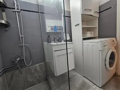 a bathroom with a shower and a washing machine at Come & Stay Apartment - Athens Town in Athens