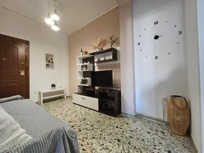 a bedroom with a bed and a clock on the wall at Come & Stay Apartment - Athens Town in Athens