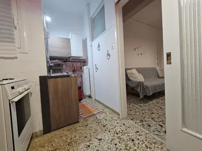 a kitchen with a sink and a room with a bed at Come & Stay Apartment - Athens Town in Athens