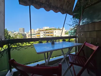 a table and two chairs on a balcony at Come & Stay Apartment - Athens Town in Athens