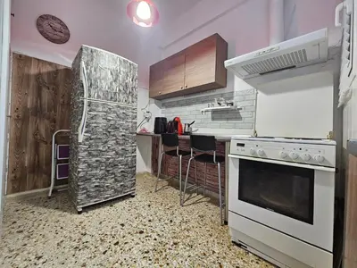 a kitchen with a stove and a refrigerator at Come & Stay Apartment - Athens Town in Athens