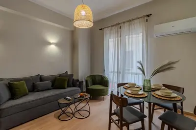 a living room with a couch and a table at Classic & Charming 2BR, Petralona Metro in Athens