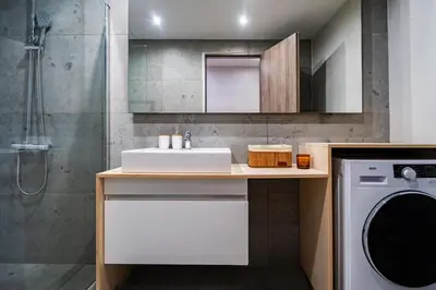 a bathroom with a sink and a washing machine at Classic & Charming 2BR, Petralona Metro in Athens