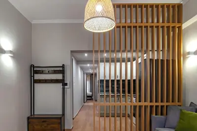 a room with a wooden wine cellar with a chandelier at Classic & Charming 2BR, Petralona Metro in Athens