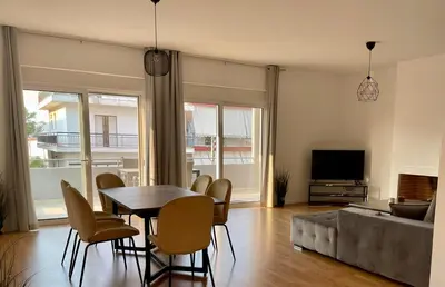 a living room with a table and chairs and a couch at Cozy Urban Retreat in Athens