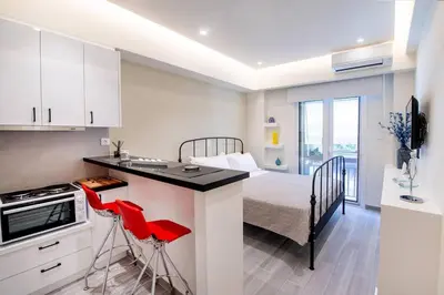 a kitchen with a sink and a bed in a room at Stylish Apartment-Κέντρο Αθήνα-15' περπάτημα από την Ακρόπολη in Athens